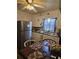 Well-lit kitchen featuring white cabinets, stainless steel refrigerator, and breakfast nook area at 2612 E 17Th Ave, Tampa, FL 33605
