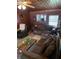 Inviting living room with wood-paneled walls and comfortable brown sofas, perfect for relaxation at 2612 E 17Th Ave, Tampa, FL 33605