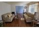 Comfortable living room featuring hardwood floors, neutral walls, and lots of natural light at 2612 E 17Th Ave, Tampa, FL 33605