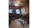 Inviting living room with wood-paneled walls and comfortable brown sofas, perfect for relaxation at 2612 E 17Th Ave, Tampa, FL 33605