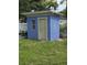 Exterior view of a small shed with a blue paint, nestled in a grassy yard at 2612 E 17Th Ave, Tampa, FL 33605