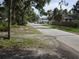 Street view of the property showcasing a residential street, mature trees, and neighboring homes at 2612 E 17Th Ave, Tampa, FL 33605
