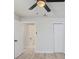 Bright bedroom featuring wood-look floors, a ceiling fan, and a closet for ample storage at 3568 Wilkinson Woods Dr # 23, Sarasota, FL 34231