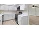 Bright kitchen with white cabinets, sleek black appliances and modern countertops at 3568 Wilkinson Woods Dr # 23, Sarasota, FL 34231