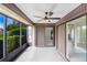 Enclosed lanai with sliding doors, a ceiling fan, and views of the backyard at 3568 Wilkinson Woods Dr # 23, Sarasota, FL 34231
