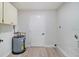 Clean laundry room with a utility sink, storage cabinets, and a water heater at 3568 Wilkinson Woods Dr # 23, Sarasota, FL 34231