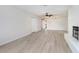 Spacious living room featuring modern flooring and a cozy white brick fireplace at 3568 Wilkinson Woods Dr # 23, Sarasota, FL 34231
