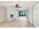 Modern living room with white brick fireplace, ceiling fan and sliding door to patio at 3568 Wilkinson Woods Dr # 23, Sarasota, FL 34231