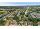 An aerial shot shows a neighborhood surrounded by canals, boats, and lush greenery at 358 Moorings Cove Dr # 4B, Tarpon Springs, FL 34689