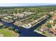 Breathtaking aerial view of a waterfront community showcasing condos, canals, docks, mature landscaping and a community pool at 358 Moorings Cove Dr # 4B, Tarpon Springs, FL 34689