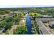 Aerial view of a waterfront home with boat access, mature trees, and serene surroundings at 358 Moorings Cove Dr # 4B, Tarpon Springs, FL 34689