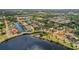An aerial view showcases the community's waterfront location with canals and lush landscaping at 358 Moorings Cove Dr # 4B, Tarpon Springs, FL 34689
