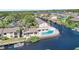 Stunning aerial view of community showcasing its pool, lush landscaping, waterfront access, and boat docks at 358 Moorings Cove Dr # 4B, Tarpon Springs, FL 34689