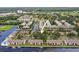 Aerial view of condos situated on waterfront with lush trees and a parking lot nearby at 358 Moorings Cove Dr # 4B, Tarpon Springs, FL 34689