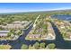 An aerial shot showcases the waterfront community with canals, boats, pools, and lush green surroundings at 358 Moorings Cove Dr # 4B, Tarpon Springs, FL 34689