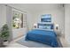 This staged bedroom features a bright window and minimalist decor at 358 Moorings Cove Dr # 4B, Tarpon Springs, FL 34689