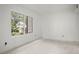 Unstaged room with a bright window and minimalist decor at 358 Moorings Cove Dr # 4B, Tarpon Springs, FL 34689