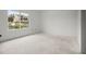 Well-lit bedroom with a window offering serene water views at 358 Moorings Cove Dr # 4B, Tarpon Springs, FL 34689