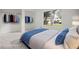 Bright bedroom featuring closet space, a large window with an outside view, and minimal furnishings for staging purposes at 358 Moorings Cove Dr # 4B, Tarpon Springs, FL 34689