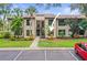 Inviting condo building with lush landscaping and convenient parking at 358 Moorings Cove Dr # 4B, Tarpon Springs, FL 34689