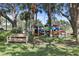 Community kayak storage area with colorful kayaks and a bench for relaxation, surrounded by trees and greenery at 358 Moorings Cove Dr # 4B, Tarpon Springs, FL 34689