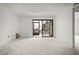 Unstaged living room with sliding glass doors leading to outdoor space and lots of natural light at 358 Moorings Cove Dr # 4B, Tarpon Springs, FL 34689