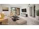 Contemporary staged living room featuring modern furniture, bright natural light and exterior access at 358 Moorings Cove Dr # 4B, Tarpon Springs, FL 34689