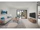 Bright, staged living room with modern decor, plush seating, and a sliding glass door to the outside at 358 Moorings Cove Dr # 4B, Tarpon Springs, FL 34689
