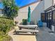 Outdoor patio features a grill, picnic table with an umbrella, and seating for relaxing or entertaining guests at 358 Moorings Cove Dr # 4B, Tarpon Springs, FL 34689