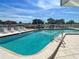Community pool with inviting blue water, surrounded by lounge chairs and serene waterfront views for ultimate relaxation at 358 Moorings Cove Dr # 4B, Tarpon Springs, FL 34689