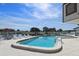 Community pool offering a relaxing escape with waterfront views, surrounded by comfortable lounge chairs and clear blue skies at 358 Moorings Cove Dr # 4B, Tarpon Springs, FL 34689