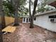 View of the backyard with a brick path and wooden fence at 4050 Iris N St, St Petersburg, FL 33703