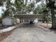 A long driveway leads to a covered carport next to the home at 4050 Iris N St, St Petersburg, FL 33703