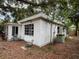 Rear view of the home showing the white siding and the backyard at 4050 Iris N St, St Petersburg, FL 33703