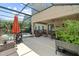 Spacious screened patio with an outdoor grill and sitting area, ideal for entertaining or relaxing in the comfort of your backyard at 5955 Caldera Ridge Dr, Lithia, FL 33547