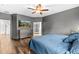 Inviting primary bedroom with wood floors and access to ensuite bathroom at 5955 Caldera Ridge Dr, Lithia, FL 33547