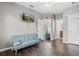 Stylish bonus room features hardwood floors, a TV and easy access to the bathroom at 5955 Caldera Ridge Dr, Lithia, FL 33547