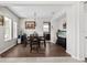 Elegant dining room with hardwood floors, a stylish chandelier, and views into the kitchen with stainless steel appliances at 5955 Caldera Ridge Dr, Lithia, FL 33547