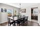 Inviting dining room with dark wood table, natural light, and open access to the kitchen, ideal for gatherings at 5955 Caldera Ridge Dr, Lithia, FL 33547