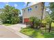 Charming two-story home featuring a red two-car garage, complemented by lush landscaping, fenced yard, and screened-in pool area at 5955 Caldera Ridge Dr, Lithia, FL 33547