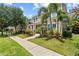 Attractive exterior view of a two-story house with palm trees and lush landscaping at 5955 Caldera Ridge Dr, Lithia, FL 33547