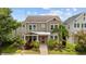 Charming two-story home featuring well-maintained landscaping and a welcoming red front door at 5955 Caldera Ridge Dr, Lithia, FL 33547