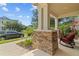 Relaxing front porch view with stone pillar bases and comfortable rocking chairs at 5955 Caldera Ridge Dr, Lithia, FL 33547