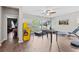 Spacious bonus room with an arcade game, foosball table, and a treadmill overlooking the backyard at 5955 Caldera Ridge Dr, Lithia, FL 33547