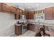Modern kitchen with stainless steel appliances, granite countertops, and wooden cabinets at 5955 Caldera Ridge Dr, Lithia, FL 33547