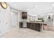 Open-concept kitchen with granite countertops, stainless steel appliances, and seamless flow to living area at 5955 Caldera Ridge Dr, Lithia, FL 33547