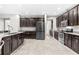 Spacious kitchen showcasing dark cabinetry, stainless steel appliances, and ample counter space at 5955 Caldera Ridge Dr, Lithia, FL 33547