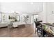 Cozy living room featuring hardwood floors, ample natural light, and seamless transition to kitchen at 5955 Caldera Ridge Dr, Lithia, FL 33547