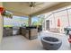 This screened patio features an outdoor kitchen with a built-in grill, sink, mini-fridge, bar, and a sleek black countertop at 5955 Caldera Ridge Dr, Lithia, FL 33547