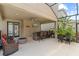 This screened-in patio boasts an outdoor kitchen, bar seating, a TV, fire pit and a dining area, ideal for entertaining guests at 5955 Caldera Ridge Dr, Lithia, FL 33547